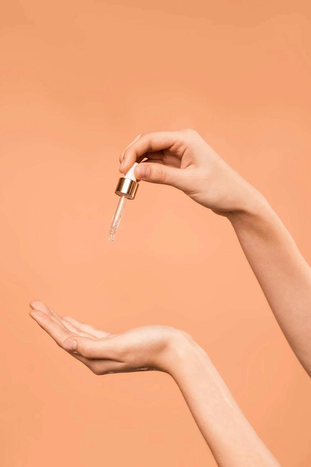 Woman applying face serum